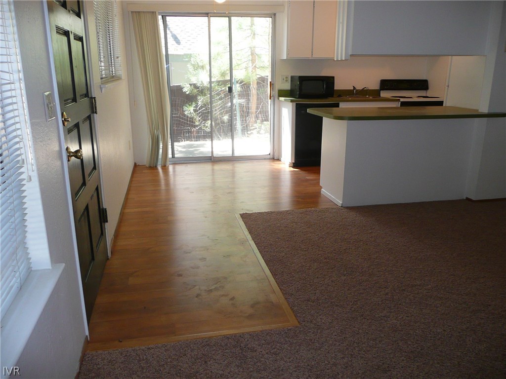 609 Village Boulevard Incline Village, NV 89451 - Photo 16 of 21 a kitchen with stainless steel appliances granite countertop a refrigerator a stove and a sink with wooden floor