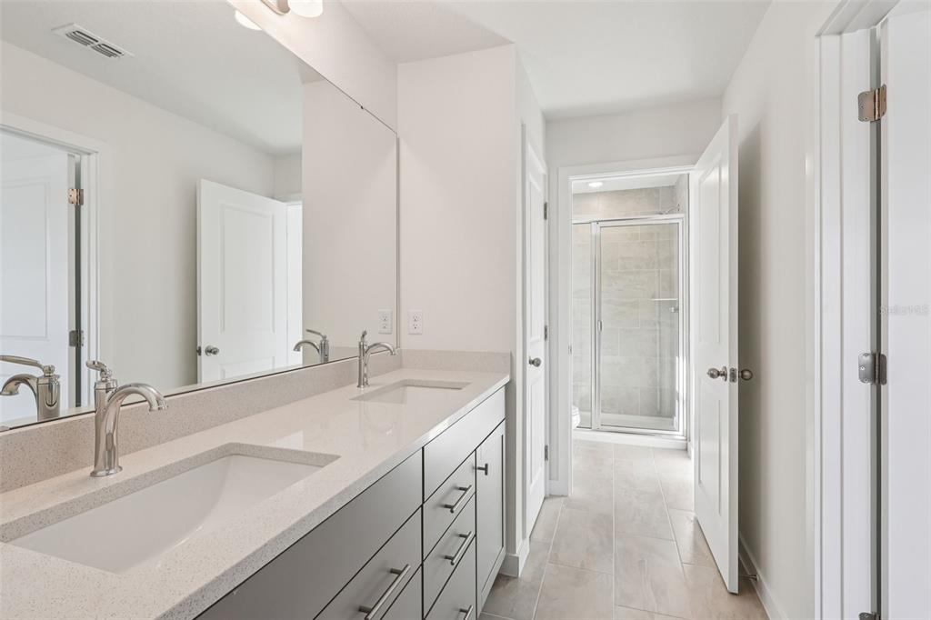 6493 Horseshoe Ln Way St. Cloud, FL 34773 - Photo 16 of 29 a spacious bathroom with a double vanity sink mirror and