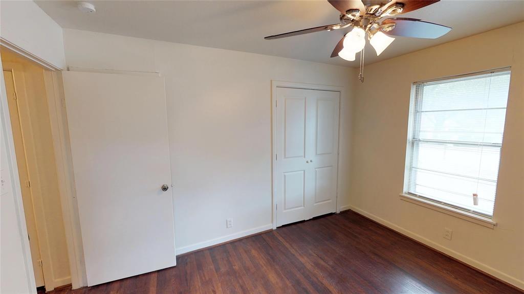 1705 Crescent Street Denton, TX 76201 - Photo 4 of 7 a view of an empty room with wooden floor and a window