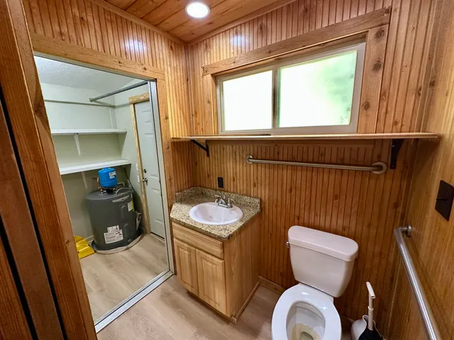 a bathroom with a sink a toilet and a shower curtain