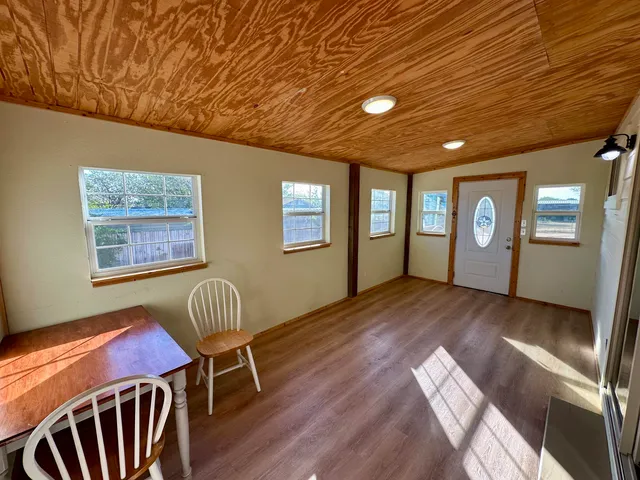 a livingroom with furniture wooden floor and windows
