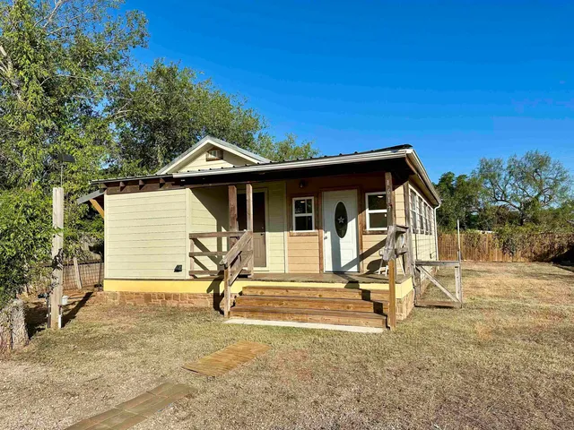 a view of a house with backyard porch and sitting area