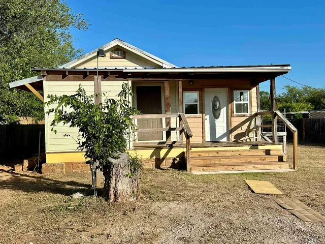 a view of a house with backyard porch and sitting area