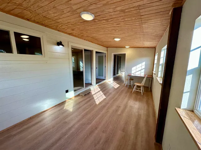 a view of a livingroom with furniture and wooden floor