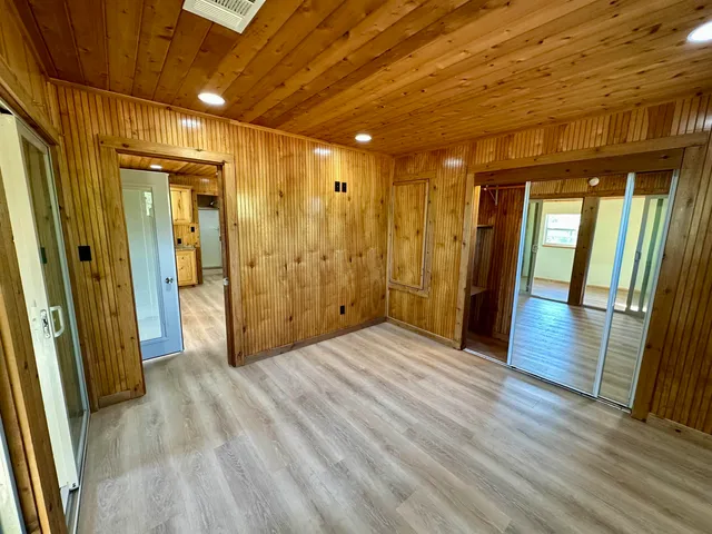 a view of hallway with wooden floor