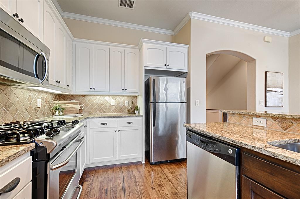 6269 Oram Street, Unit 10 Dallas, TX 75214 - Photo 8 of 25 a kitchen with granite countertop a sink stove and refrigerator