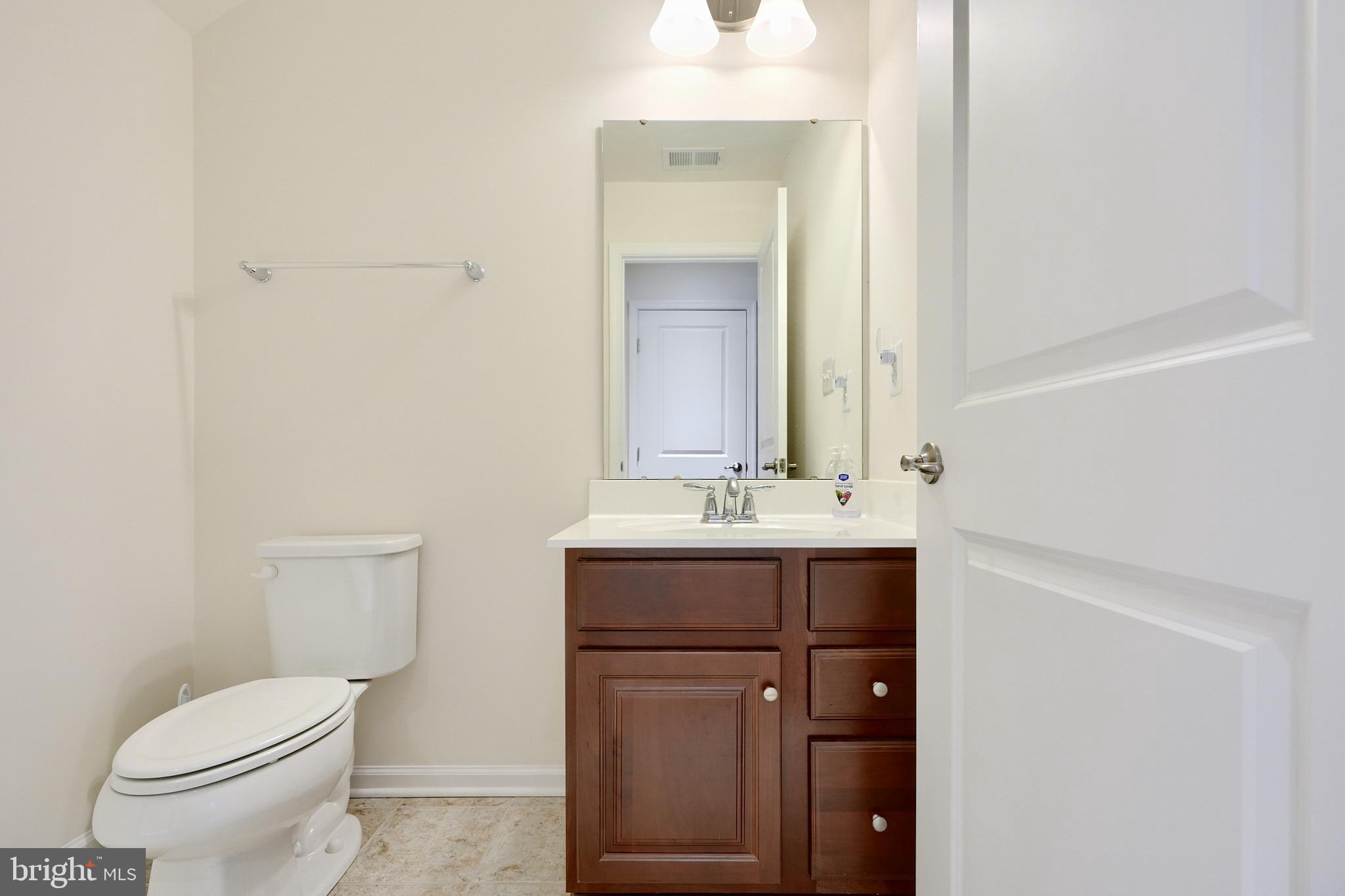 814 Oldham Street Baltimore, MD 21224 - Photo 35 of 45 a bathroom with a sink a toilet and mirror