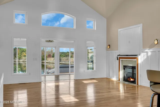 a kitchen with stainless steel appliances granite countertop a stove a refrigerator a kitchen island a sink cabinets and a refrigerator