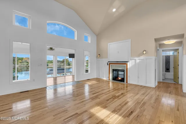 a kitchen with stainless steel appliances granite countertop a stove a refrigerator a kitchen island a dining table and chairs