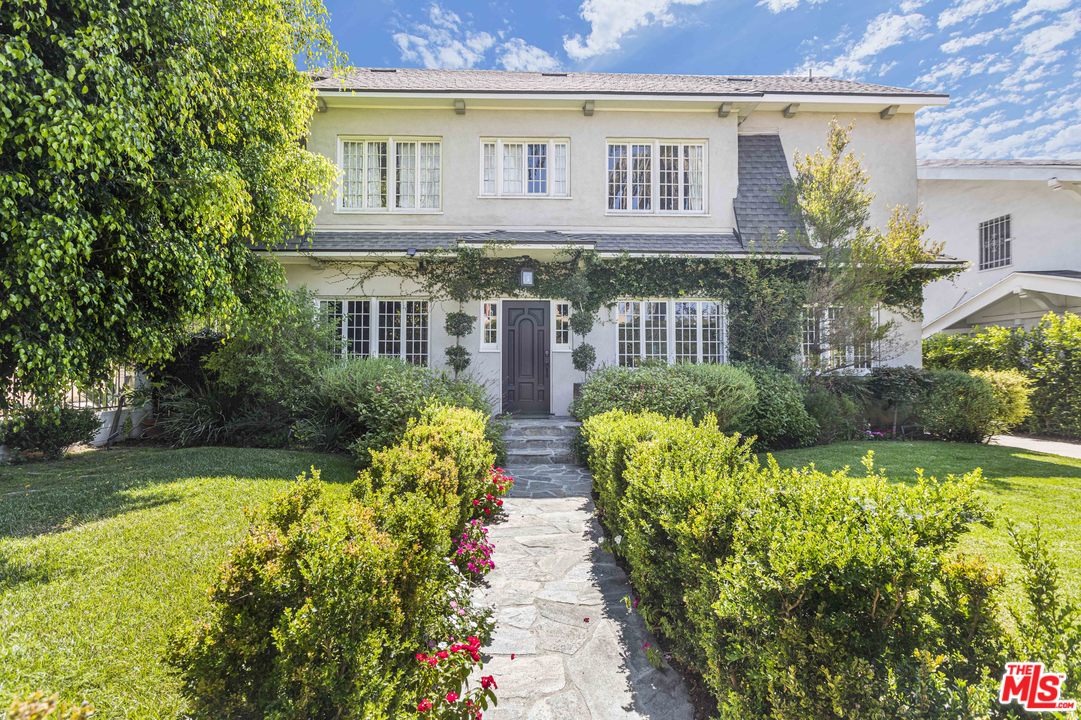 1908 Buckingham Road Los Angeles, CA 90016 - Photo 1 of 39 a view of house with a yard and potted plants