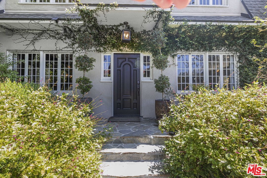 1908 Buckingham Road Los Angeles, CA 90016 - Photo 2 of 39 a front view of a house with a garden