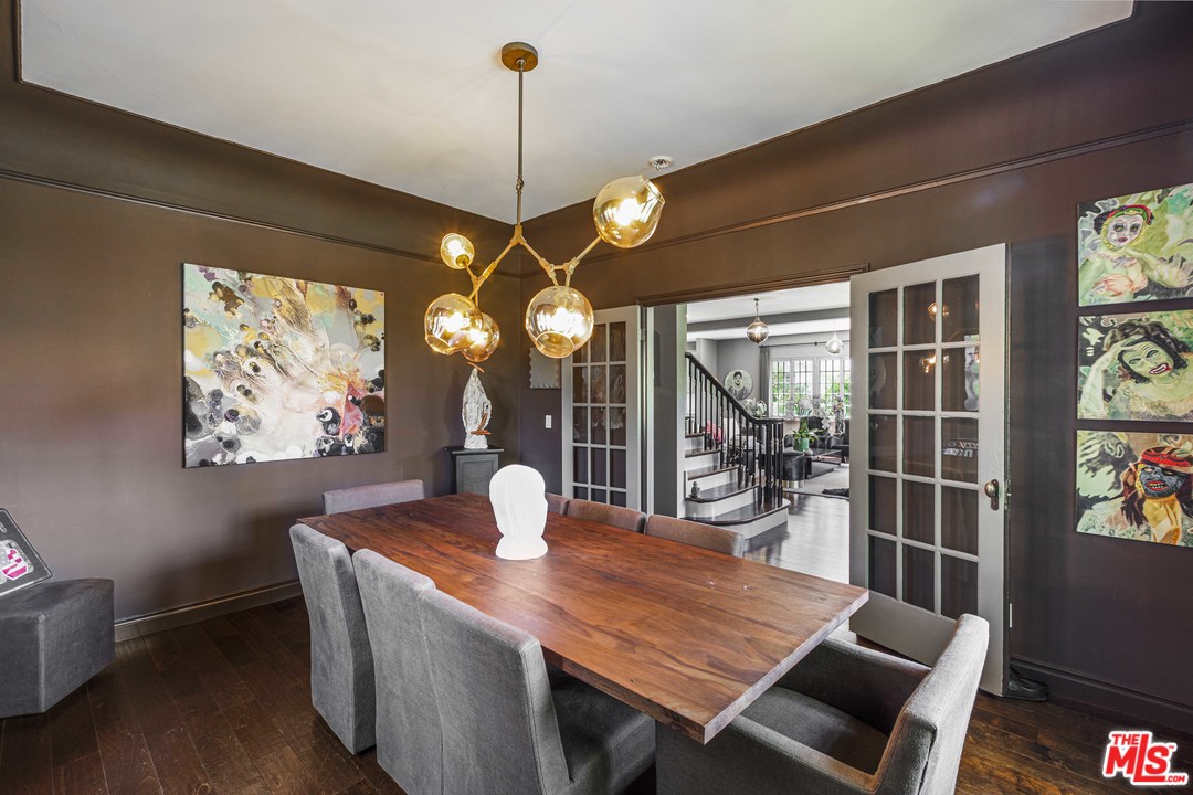 1908 Buckingham Road Los Angeles, CA 90016 - Photo 14 of 39 a view of a dining room with furniture a chandelier and wooden floor