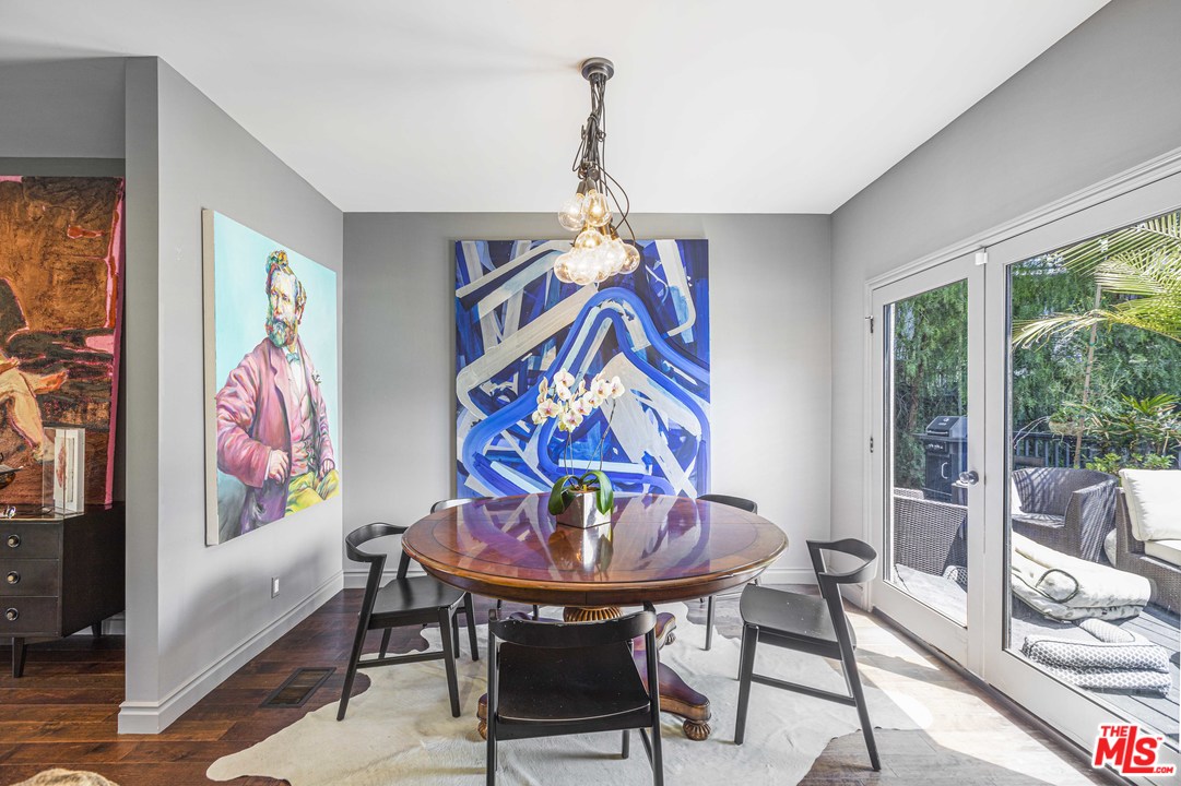 1908 Buckingham Road Los Angeles, CA 90016 - Photo 18 of 39 a view of a dining room with furniture a chandelier and a window