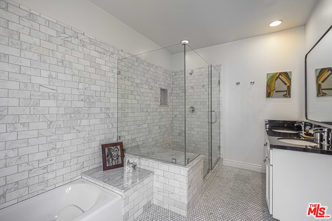 1908 Buckingham Road Los Angeles, CA 90016 - Photo 24 of 39 a bathroom with a granite countertop sink a toilet and shower