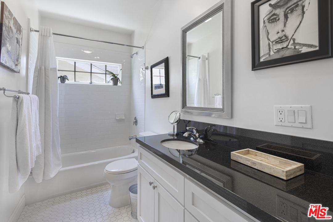 1908 Buckingham Road Los Angeles, CA 90016 - Photo 28 of 39 a bathroom with a toilet a sink and mirror
