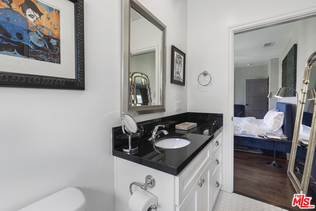 1908 Buckingham Road Los Angeles, CA 90016 - Photo 29 of 39 a bathroom with a sink vanity and a toilet
