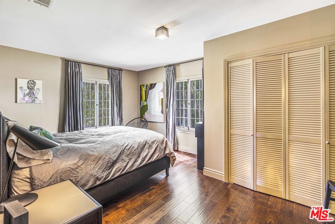 1908 Buckingham Road Los Angeles, CA 90016 - Photo 30 of 39 a bedroom with a bed and wooden floor