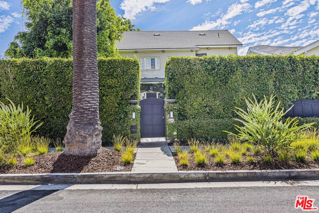1908 Buckingham Road Los Angeles, CA 90016 - Photo 4 of 39 front view of a house with a yard and potted plants