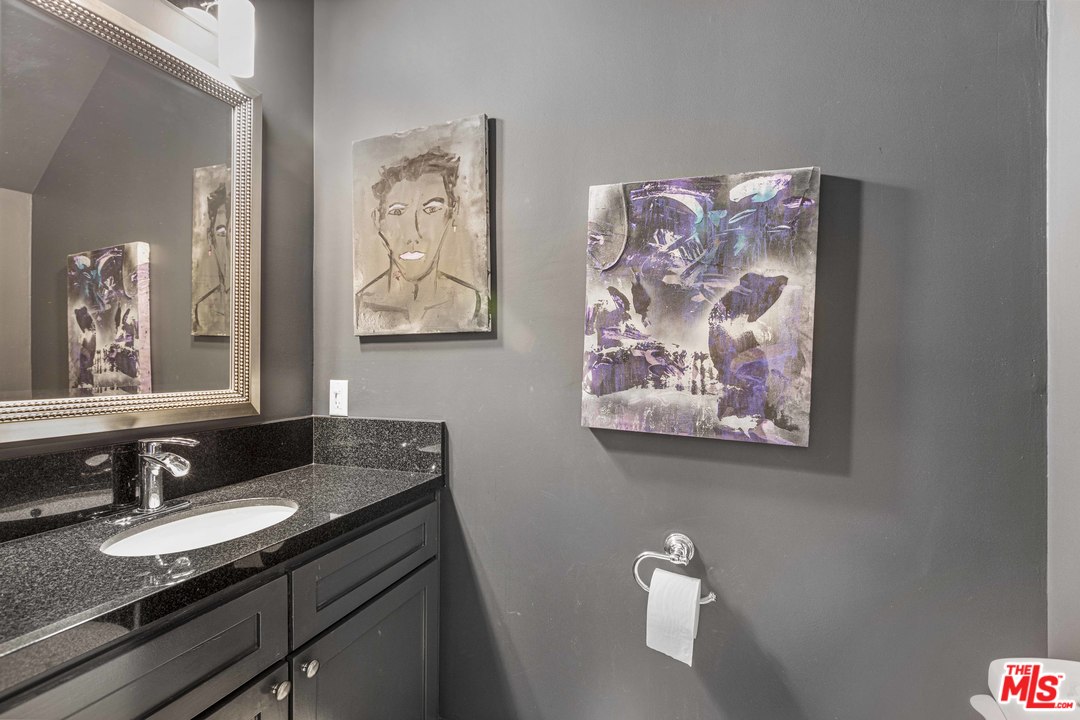 1908 Buckingham Road Los Angeles, CA 90016 - Photo 33 of 39 a bathroom with a sink and a mirror