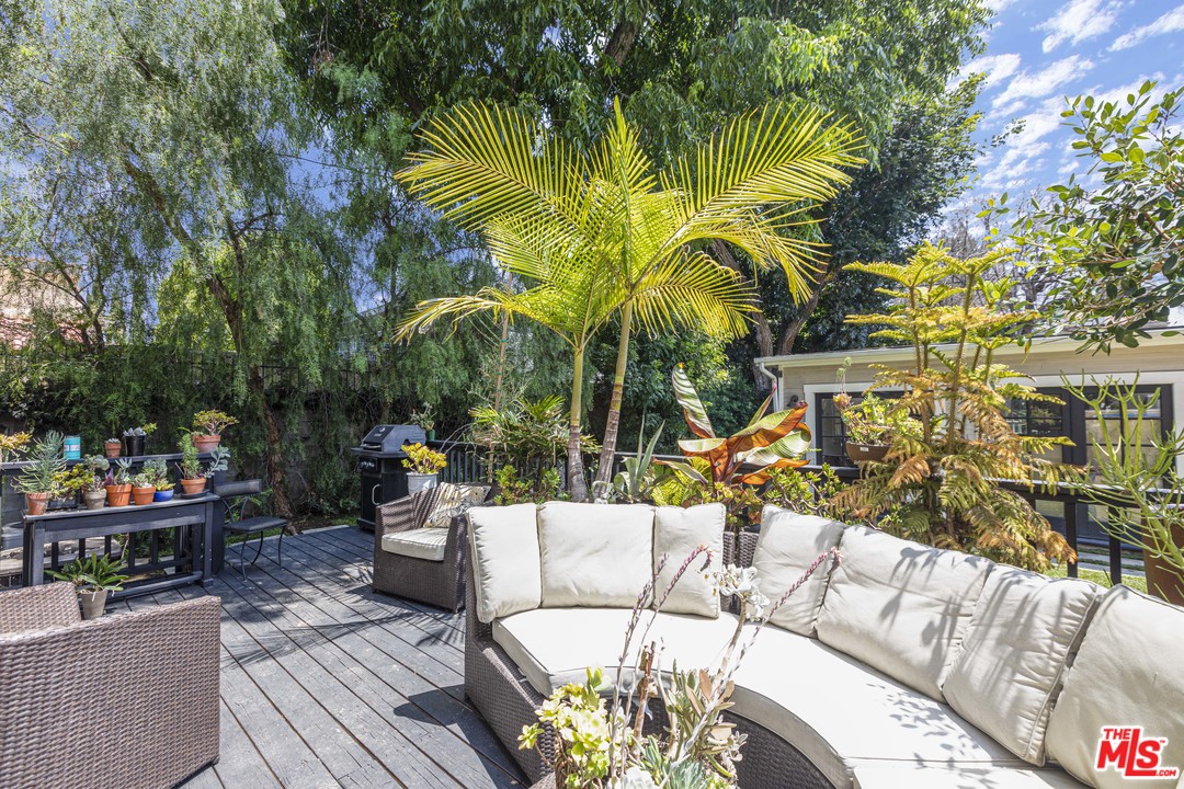 1908 Buckingham Road Los Angeles, CA 90016 - Photo 35 of 39 a view of a patio with couches table and chairs and potted plants
