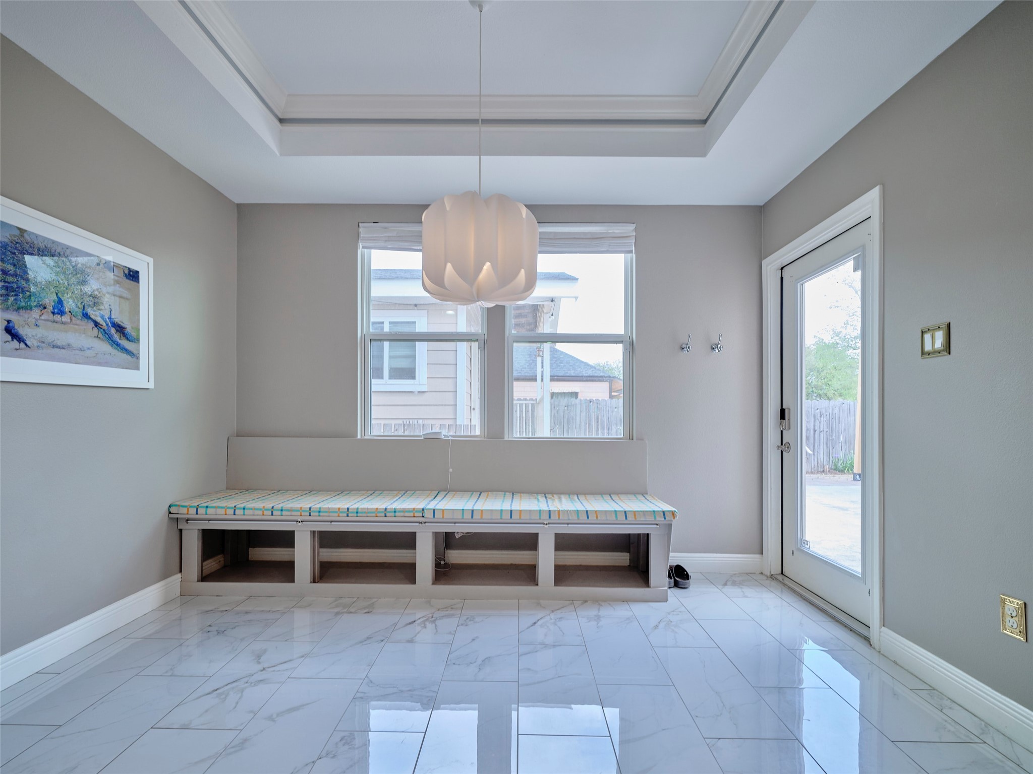4219 Redbud Street Houston, TX 77051 - Photo 12 of 25 This inviting breakfast area features a spacious, cozy bench perfect for relaxed mornings and intimate gatherings, all bathed in natural light.