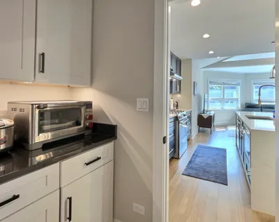 a living room with furniture kitchen view and a table