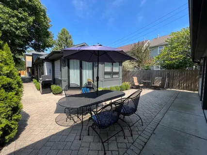 an aerial view of a house with garden space and swimming pool