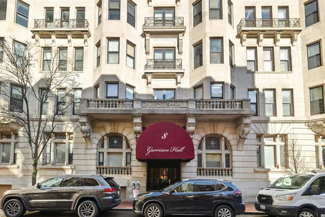 a front view of a building with parking space