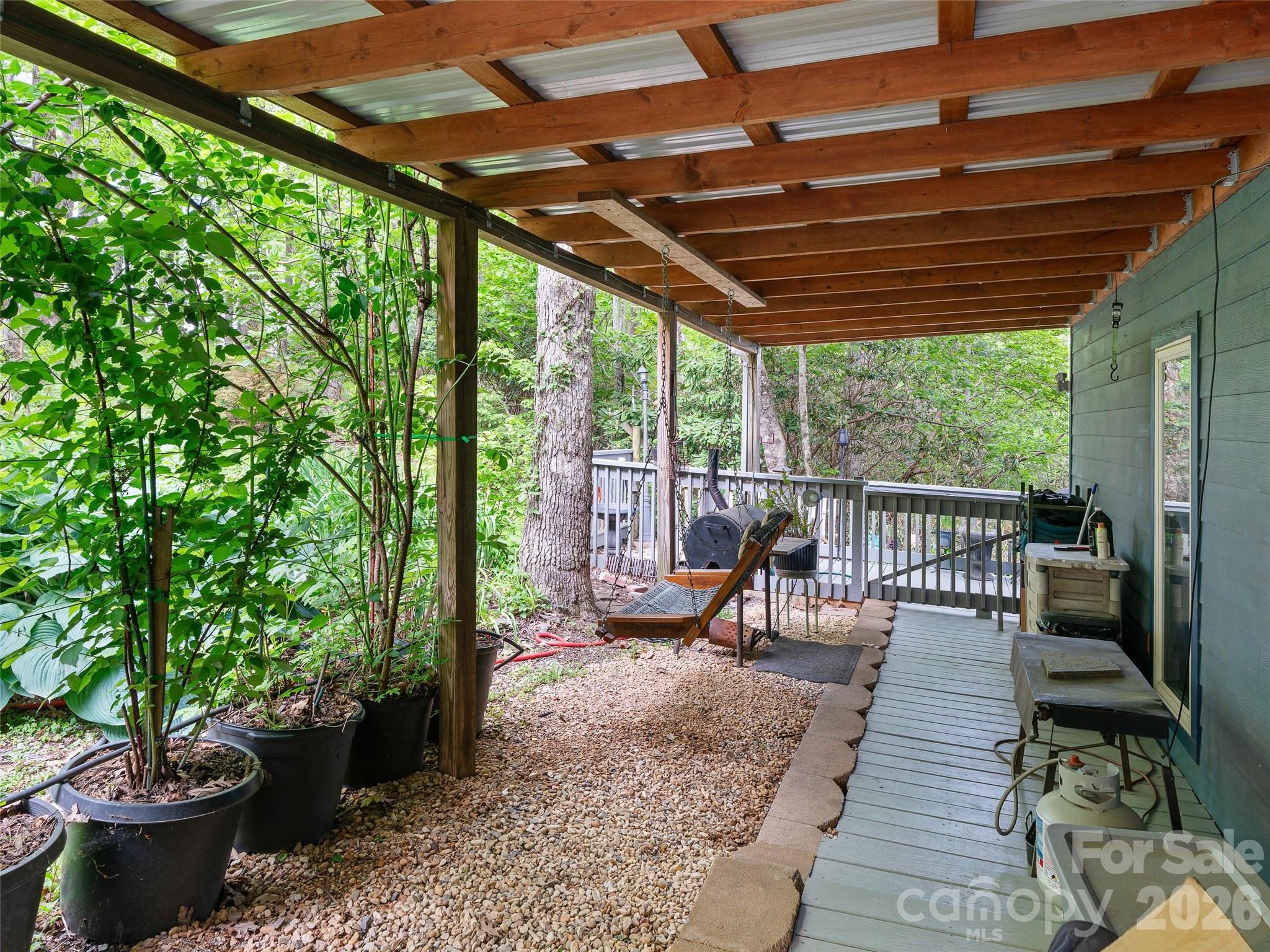 228 Continental Divide Road Spruce Pine, NC 28777 - Photo 31 of 48 a view of a patio with chairs and potted plants
