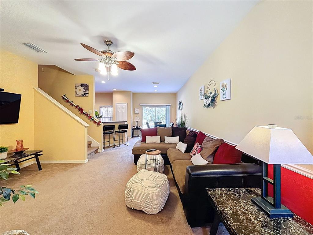 11807 Castine Street New Port Richey, FL 34654 - Photo 9 of 40 a living room with furniture a rug and white walls