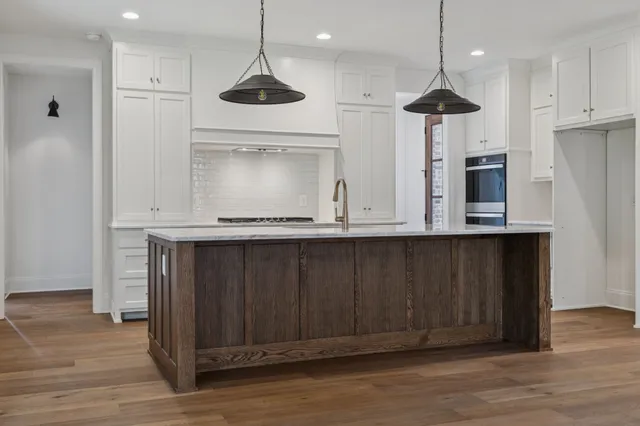 a spacious bedroom with a bed and a chandelier