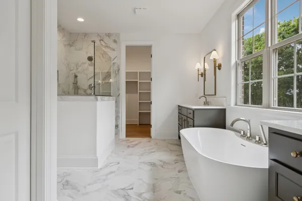 a view of a bathroom with a tub and shower