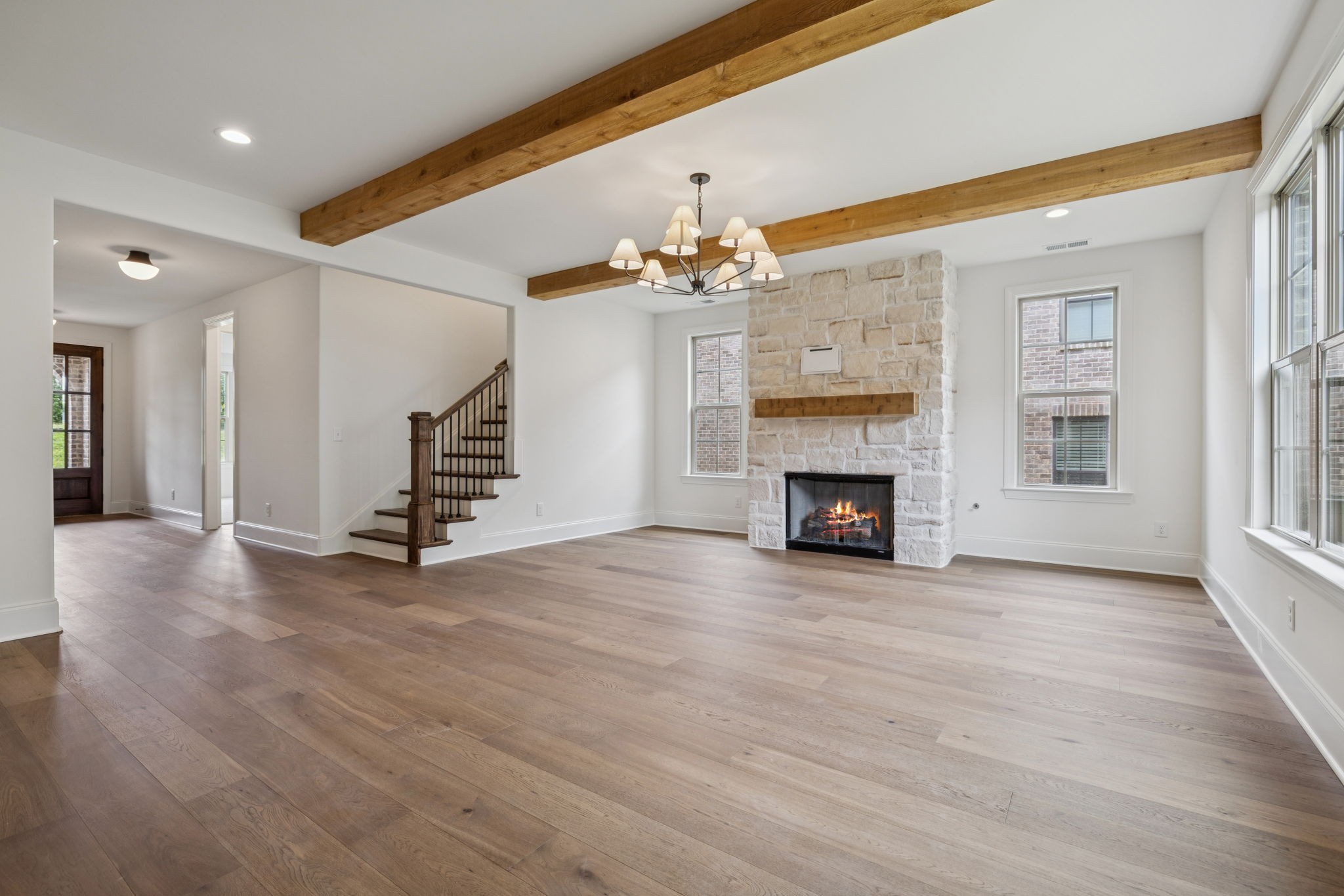 217 Bellsford Road Gallatin, TN 37066 - Photo 16 of 73 an empty room with wooden floor fireplace and windows