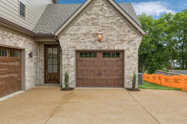 an empty room with wooden floor fireplace and windows