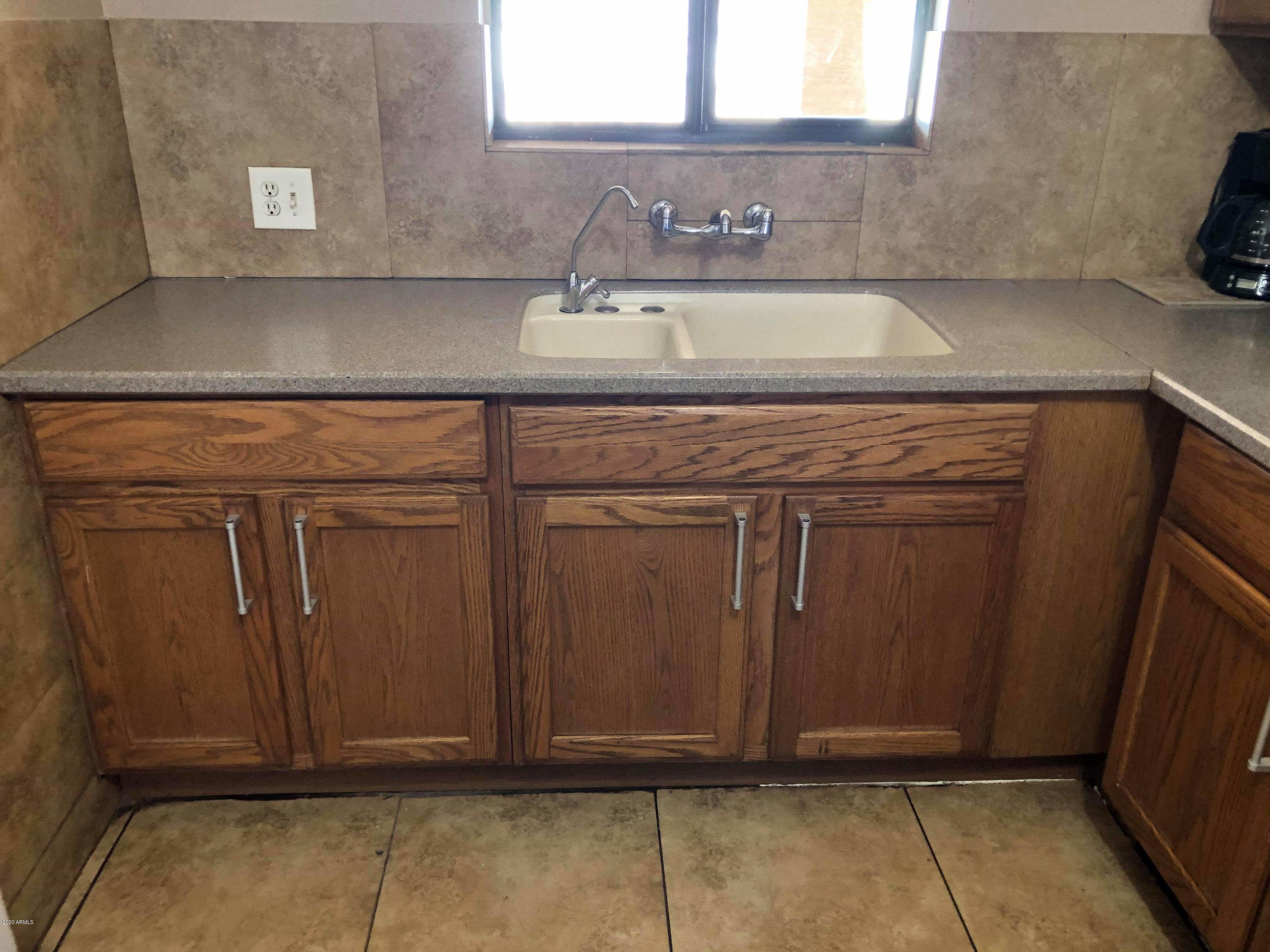3601 West Coronado Road Phoenix, AZ 85009 - Photo 3 of 8 a close view of sink and cabinets