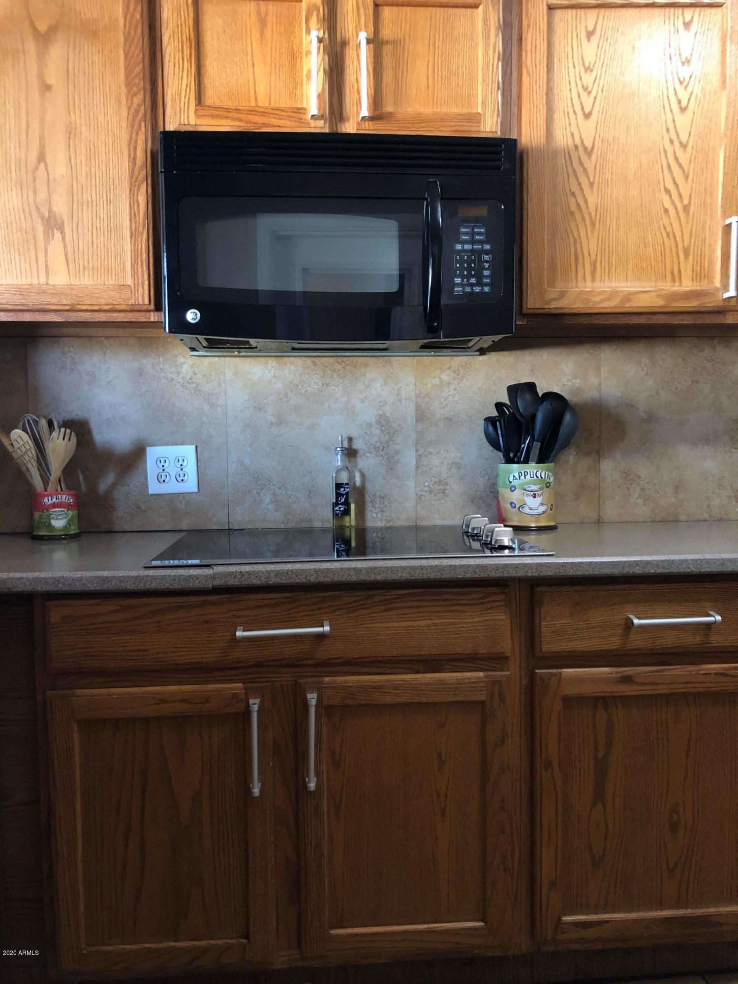 3601 West Coronado Road Phoenix, AZ 85009 - Photo 4 of 8 a kitchen with stainless steel appliances granite countertop a sink a stove and microwave