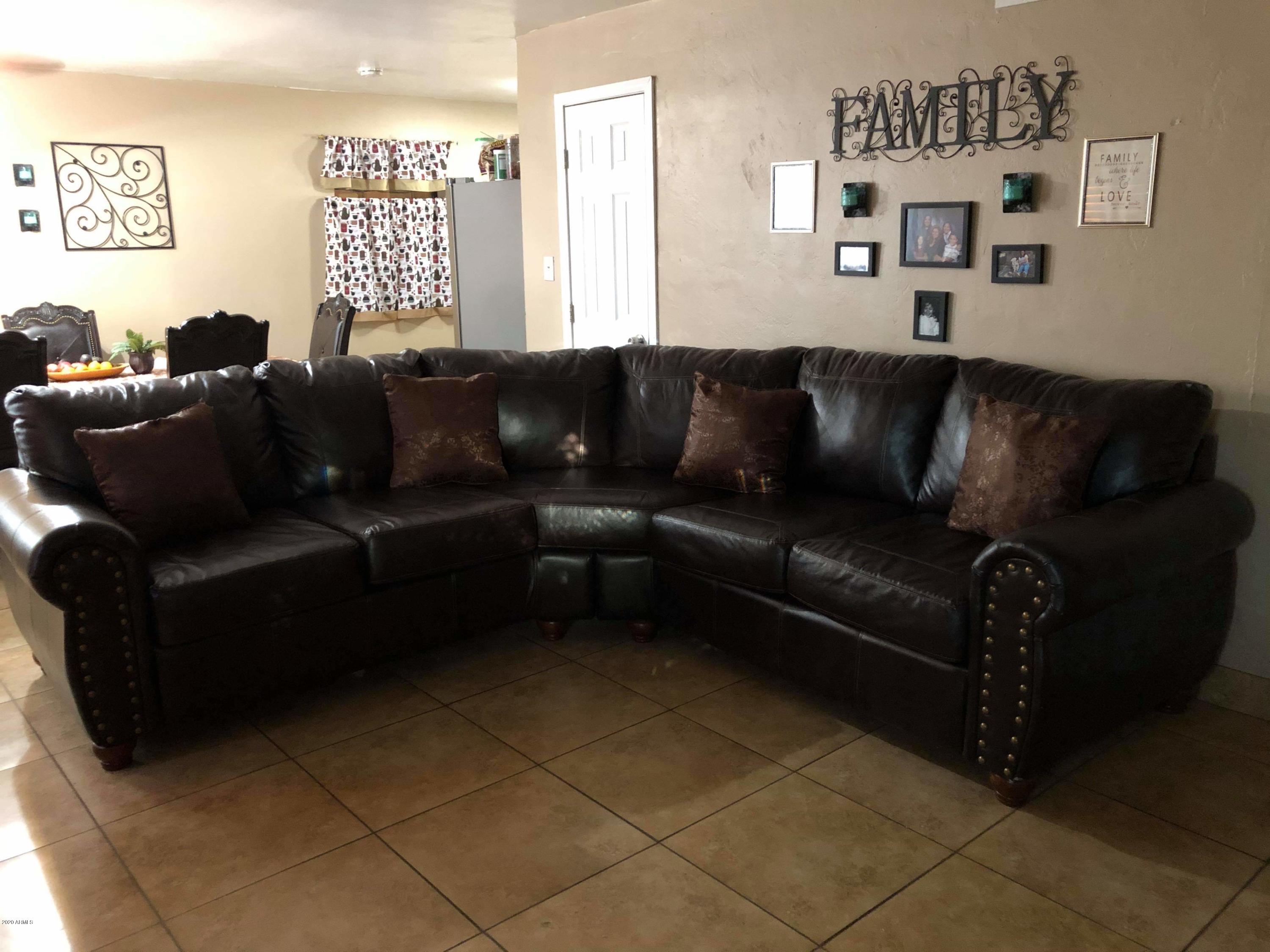 3601 West Coronado Road Phoenix, AZ 85009 - Photo 6 of 8 a living room with a couch and a window