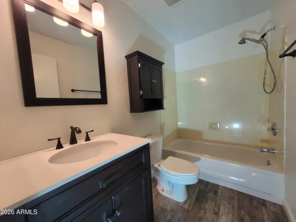 a bathroom with a toilet a sink and a mirror