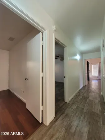 a view of a hallway with wooden floor
