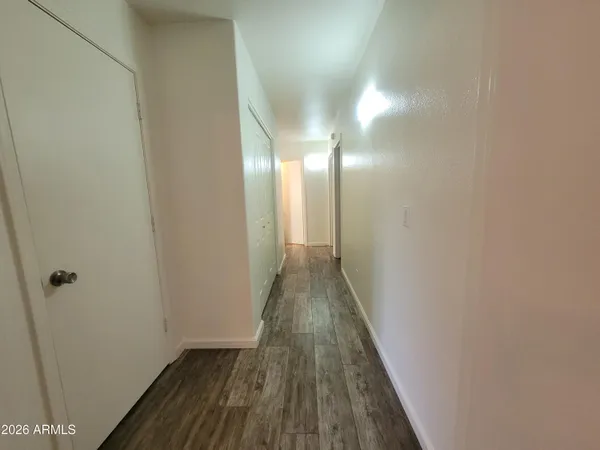 a view of a hallway with wooden floor