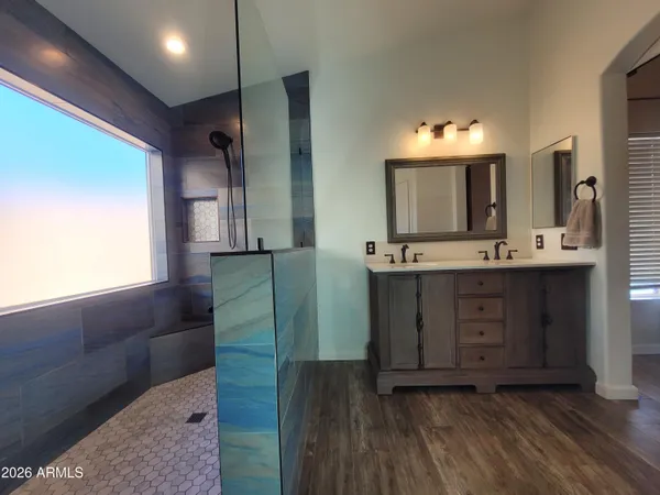 a bathroom with a double vanity sink and mirror