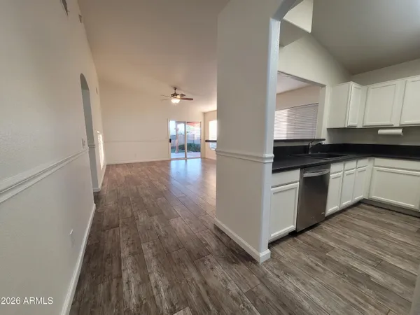 a kitchen with granite countertop a stove top oven and cabinets