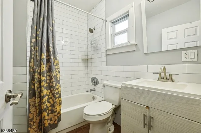 a bathroom with a sink toilet vanity and tub