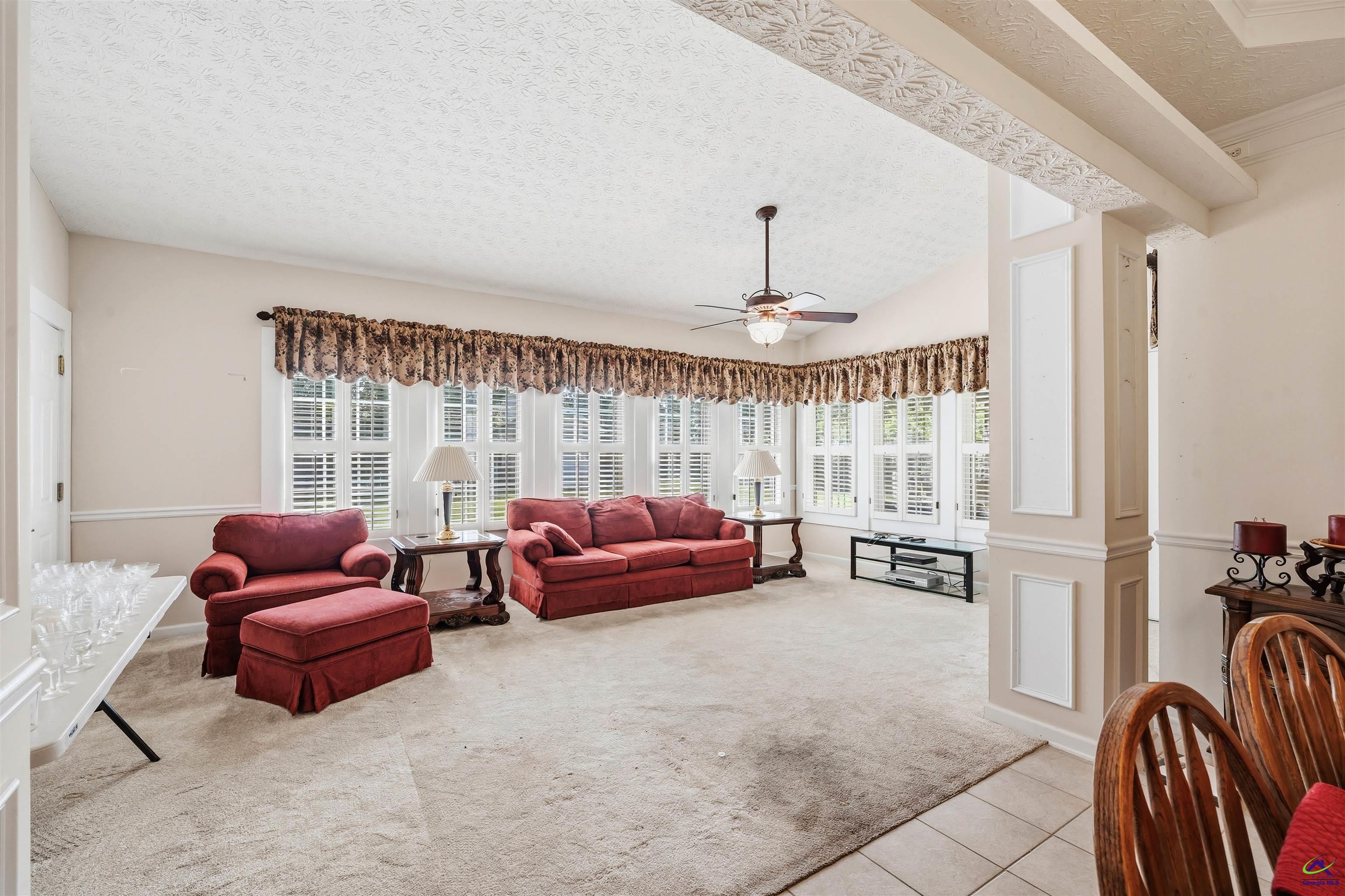 206 North Hampton Place Perry, GA 31069 - Photo 15 of 20 a living room with furniture and a chandelier
