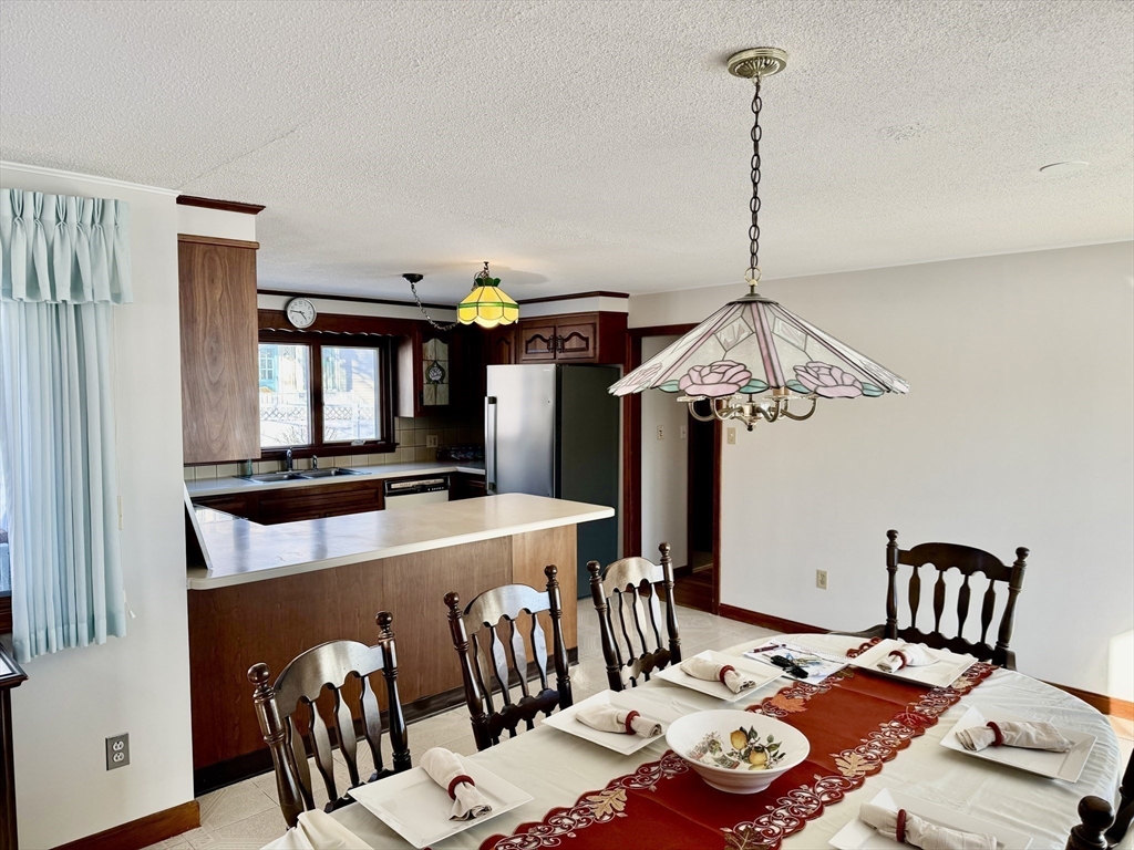 24 Flume Road Gloucester, MA 01930 - Photo 13 of 40 a view of a dining room with furniture and wooden floor
