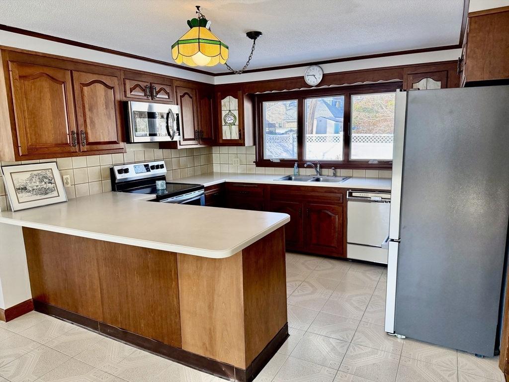24 Flume Road Gloucester, MA 01930 - Photo 15 of 40 a kitchen with stainless steel appliances granite countertop a stove and a sink