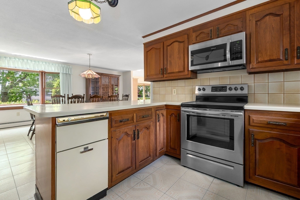24 Flume Road Gloucester, MA 01930 - Photo 16 of 40 a kitchen with stainless steel appliances granite countertop a stove microwave and cabinets