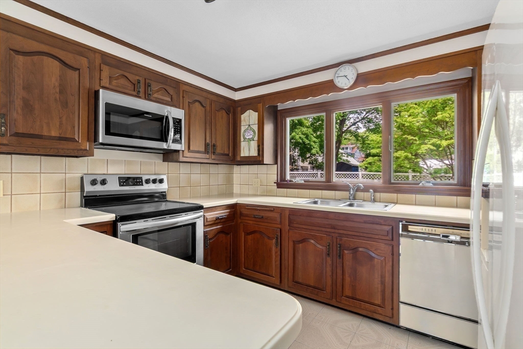 24 Flume Road Gloucester, MA 01930 - Photo 17 of 40 a kitchen with stainless steel appliances a stove sink microwave and cabinets
