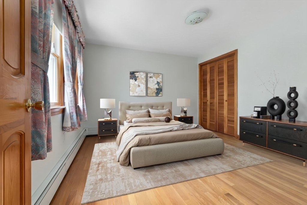 24 Flume Road Gloucester, MA 01930 - Photo 26 of 40 a spacious bedroom with a bed a couch and dresser