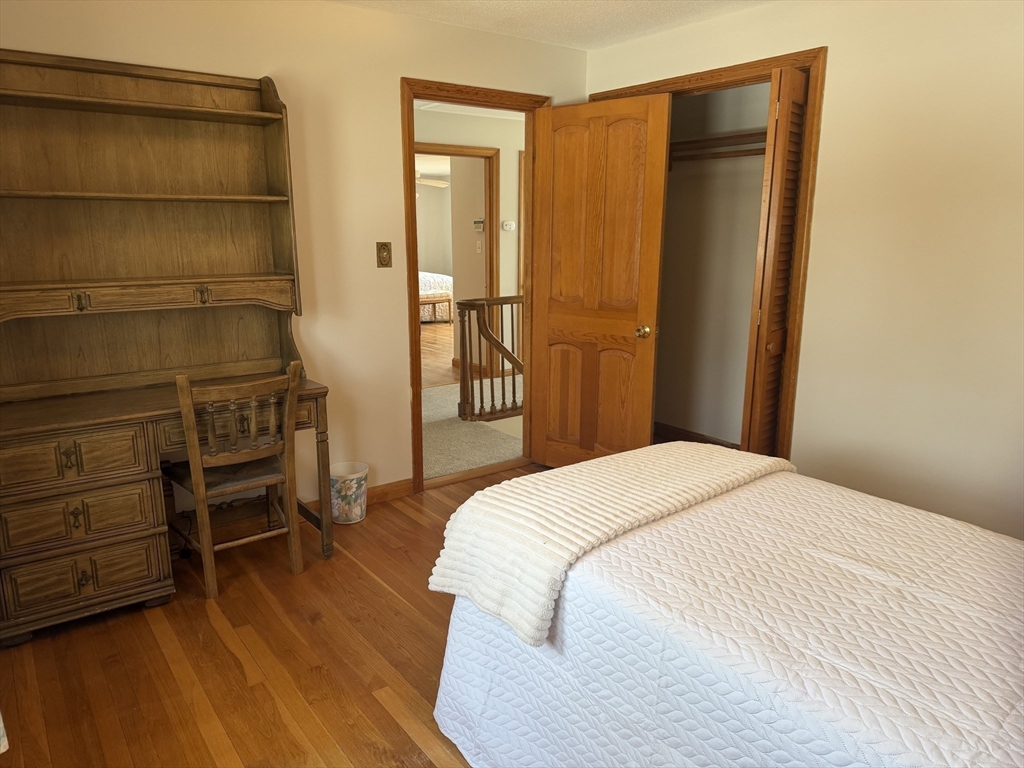 24 Flume Road Gloucester, MA 01930 - Photo 27 of 40 a bedroom with a bed and a cabinets